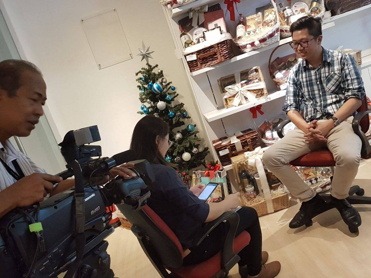 Alexis Tan being interviewed by a TV crew